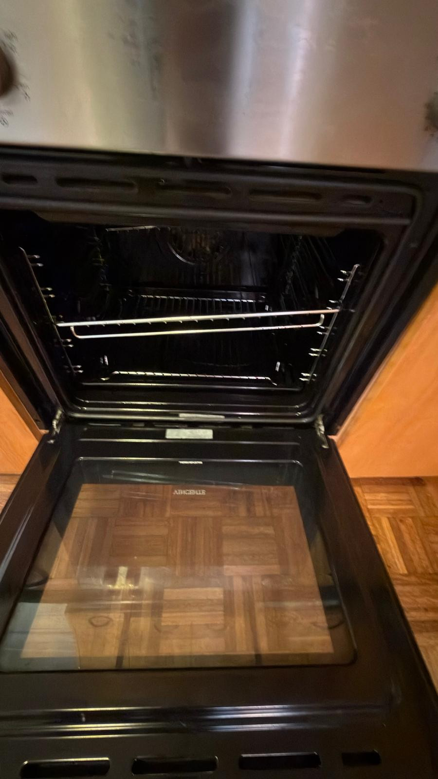 Front view of an open oven with its racks in place